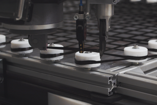 Close-up showing how a robot lays carbon fiber